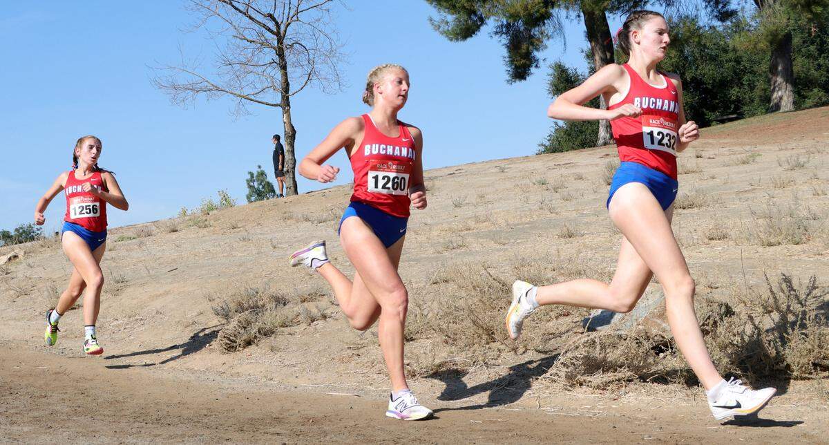 Buchanan High senior Stefania Sesock, the eventual winner in 17:56.89, chases teammates Avery Hutchison and Tayler Torosian heading into the first mle of the TRAC cross country championships at Woodward Park on Nov. 9, 2023.