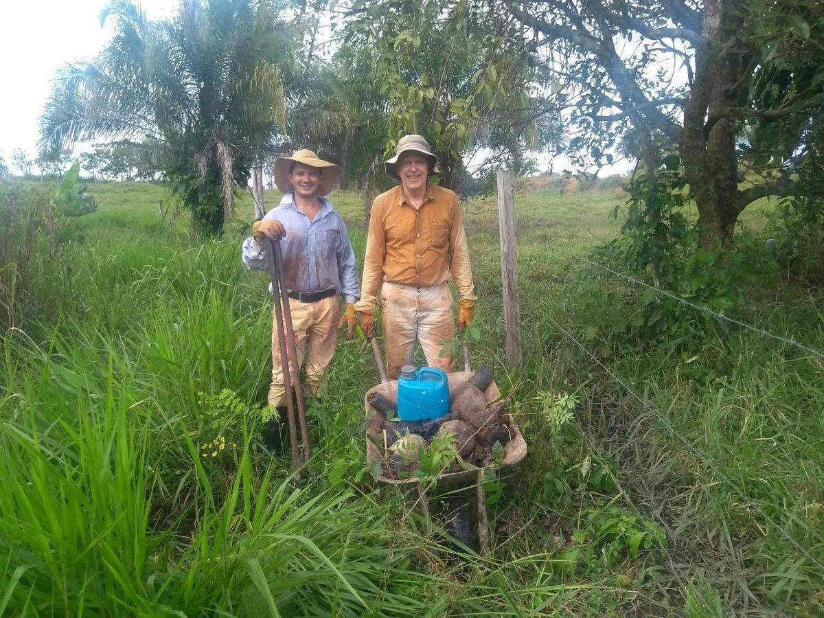 Mark Mitchell, right, with husband Paulo Mendonca planting trees at their ranch in Brazil last year.