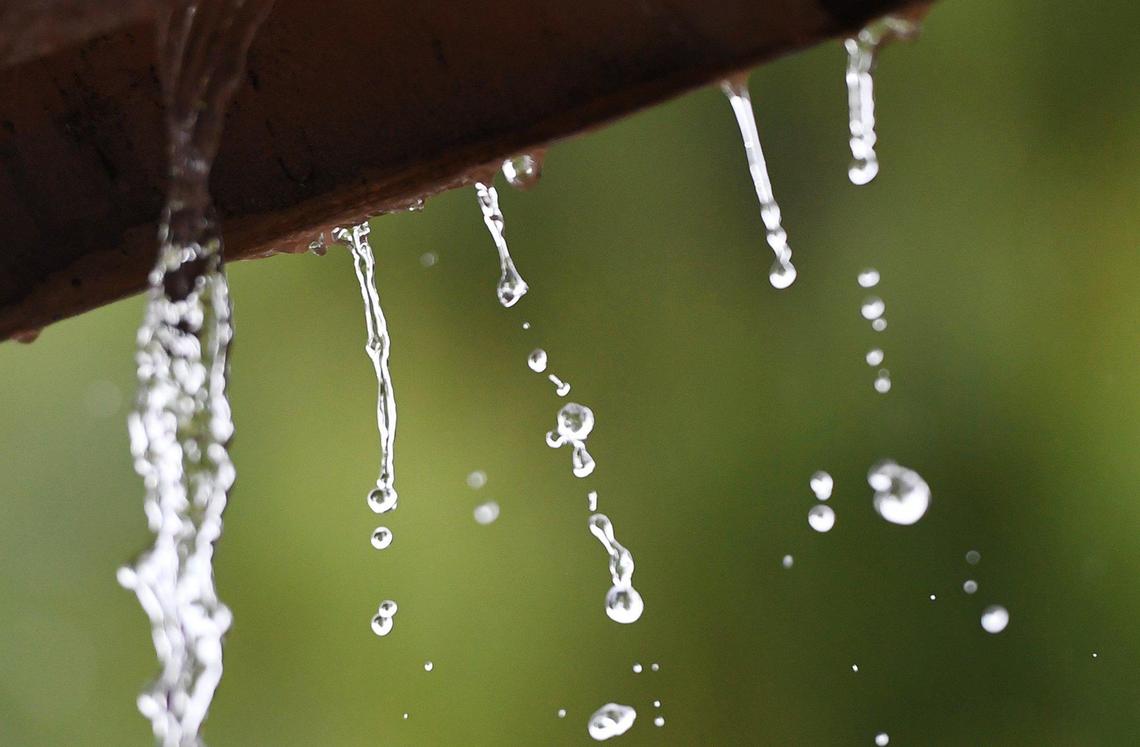 Rain streams from a roof as this weekÕs storm continues Thursday, Jan. 28, 2021 in Fresno.