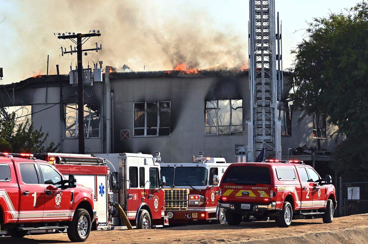 Firefighters respond as the former Fresno County Coroner’s building burns Tuesday morning, Sept. 24, 2024 in Fresno.