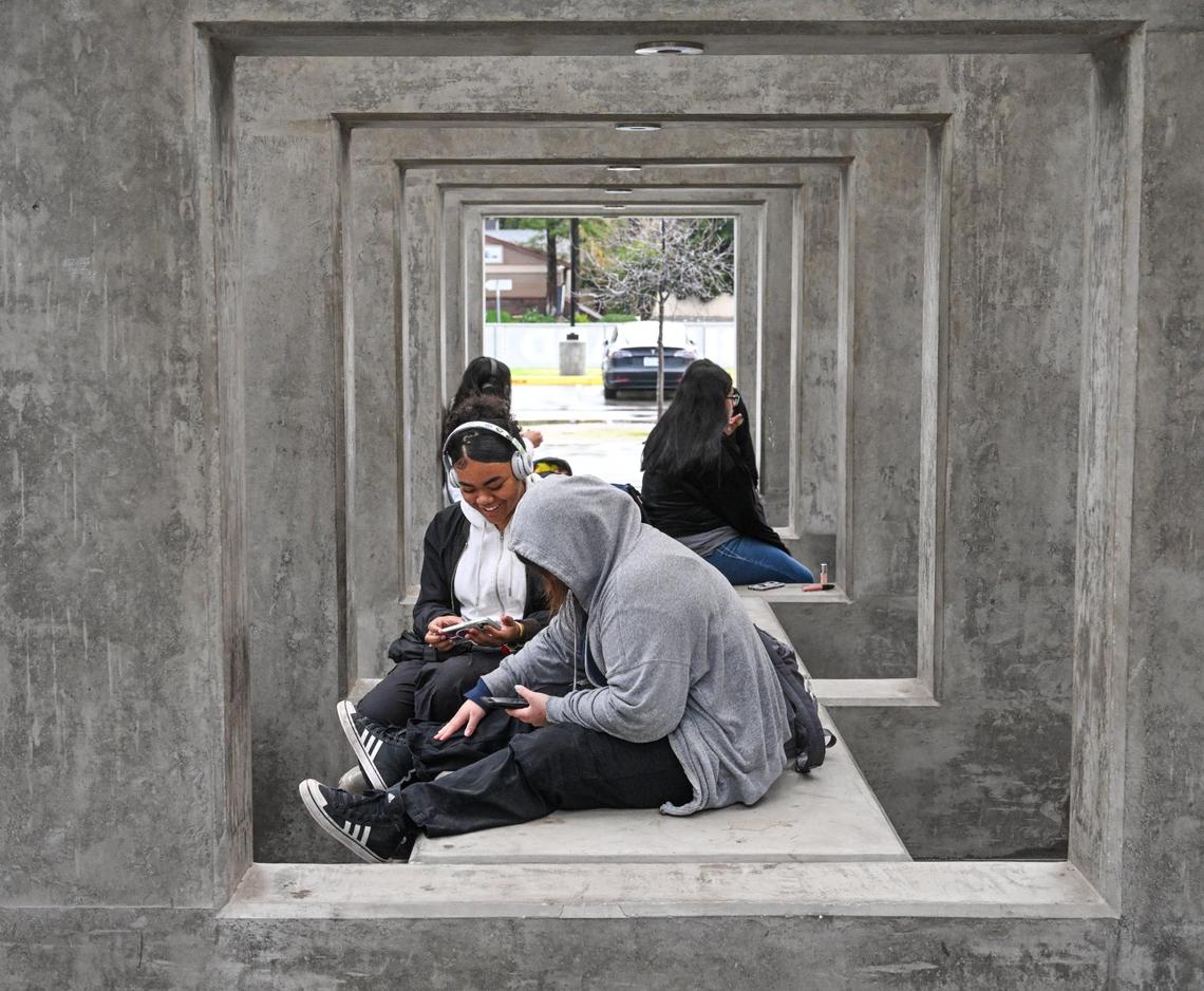 Bullard High School students sit with their cell phones before the start of classes on Monday, Jan. 22, 2024. Students at Bullard must store their phones in locked Yondr pouches until after the school day ends when they can be unlocked with a magnetic device.