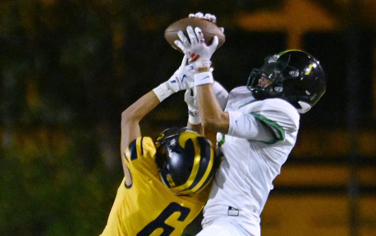 Roosevelt’s Fermin Solorzano, right, makes the catch covered by Sunnyside’s Joe Dominguez, left, Friday, Oct. 4, 2024 in Fresno.