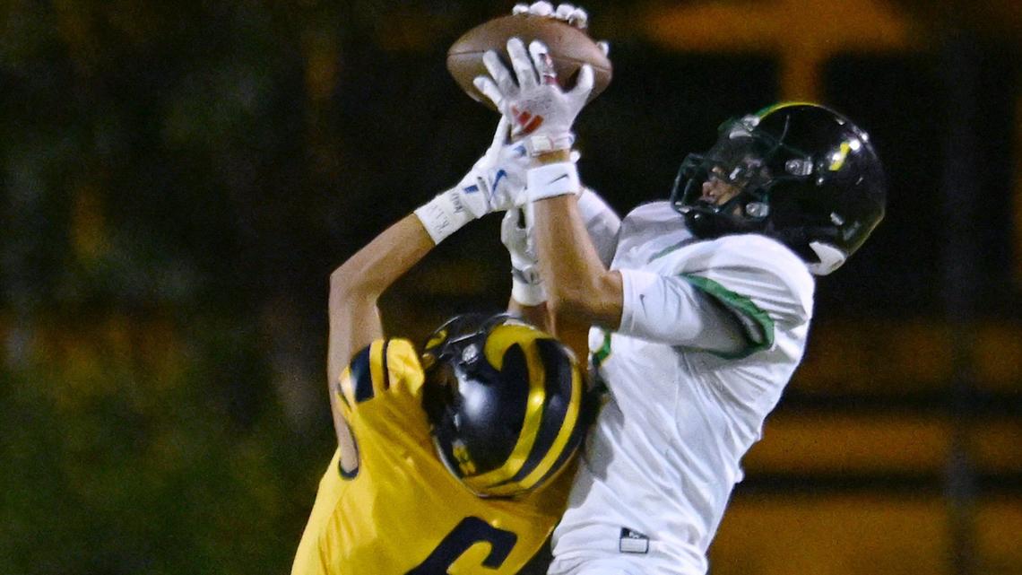 Roosevelt’s Fermin Solorzano, right, makes the catch covered by Sunnyside’s Joe Dominguez, left, Friday, Oct. 4, 2024 in Fresno.
