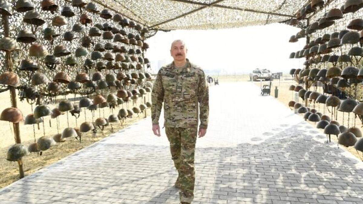 Azerbaijan’s President Ilham Aliyev walks through a display of helmets of Armenian soldiers during the inauguration the Military Trophy Park in Baku. Armenia and Azerbaijan fought for disputed territory last year. Russia negotiated a cease fire after Azeri forces, aided by Turkey, took back land previously under Armenian control.