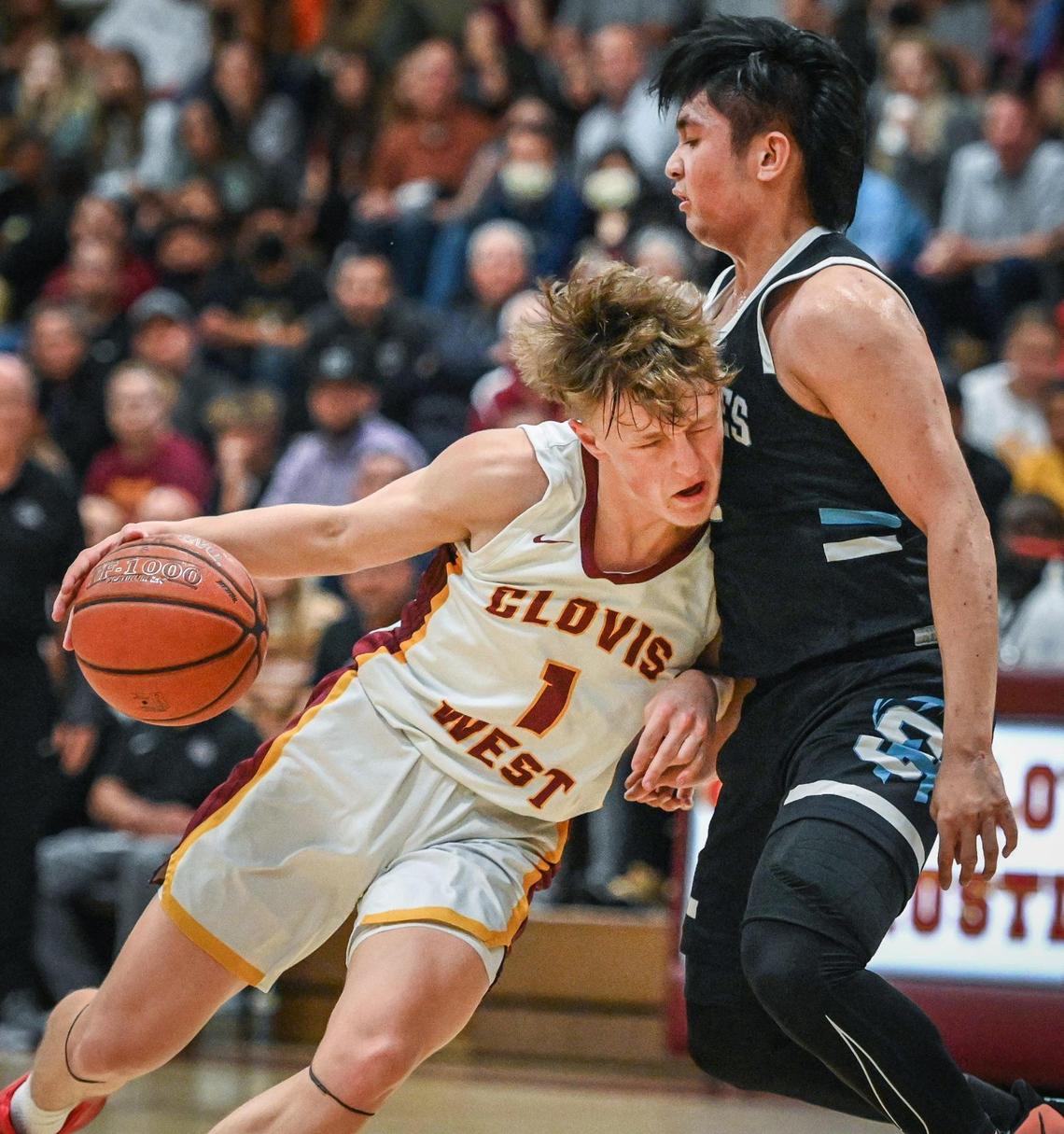 Clovis West’s Jackson Young, left, collides with Sheldon’s Jacob Sandino while driving toward the hoop during their CIF NorCal Open Division state playoff basketball game at Clovis West on Wednesday, March 2, 2022.