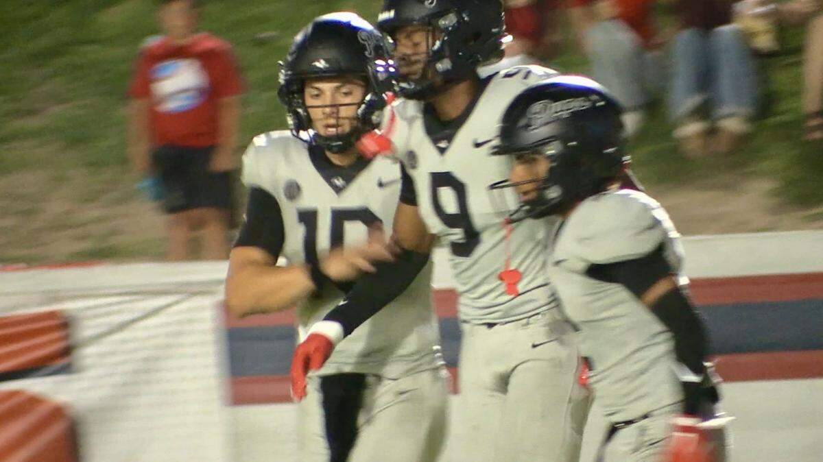 Hanford High quarterback Daniel Gomez, left, congratulates JC Turner, middle, after throwing a touchdown against Sanger on Friday, Aug. 30, 2024.