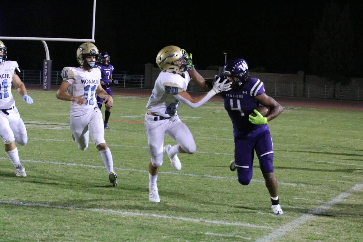 Running back Joshua Vega uses a stiff arm to get a few more yards for Washington Union on Friday against Monache.