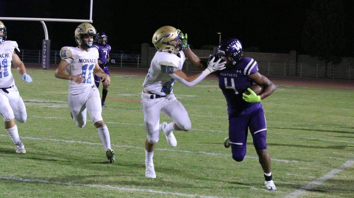 Running back Joshua Vega uses a stiff arm to get a few more yards for Washington Union on Friday against Monache.