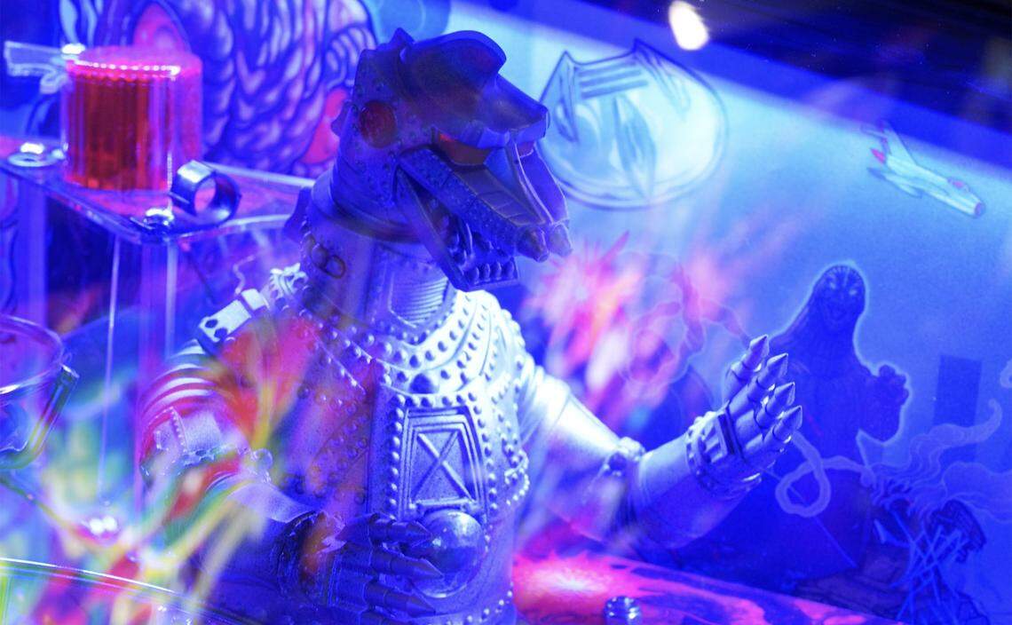 Mechagodzilla is seen on a pinball machine during Fresno Flip or Fail Pinball Club’s pop-up at Summer Fox Saturday, Dec. 6, 2025 in Clovis.