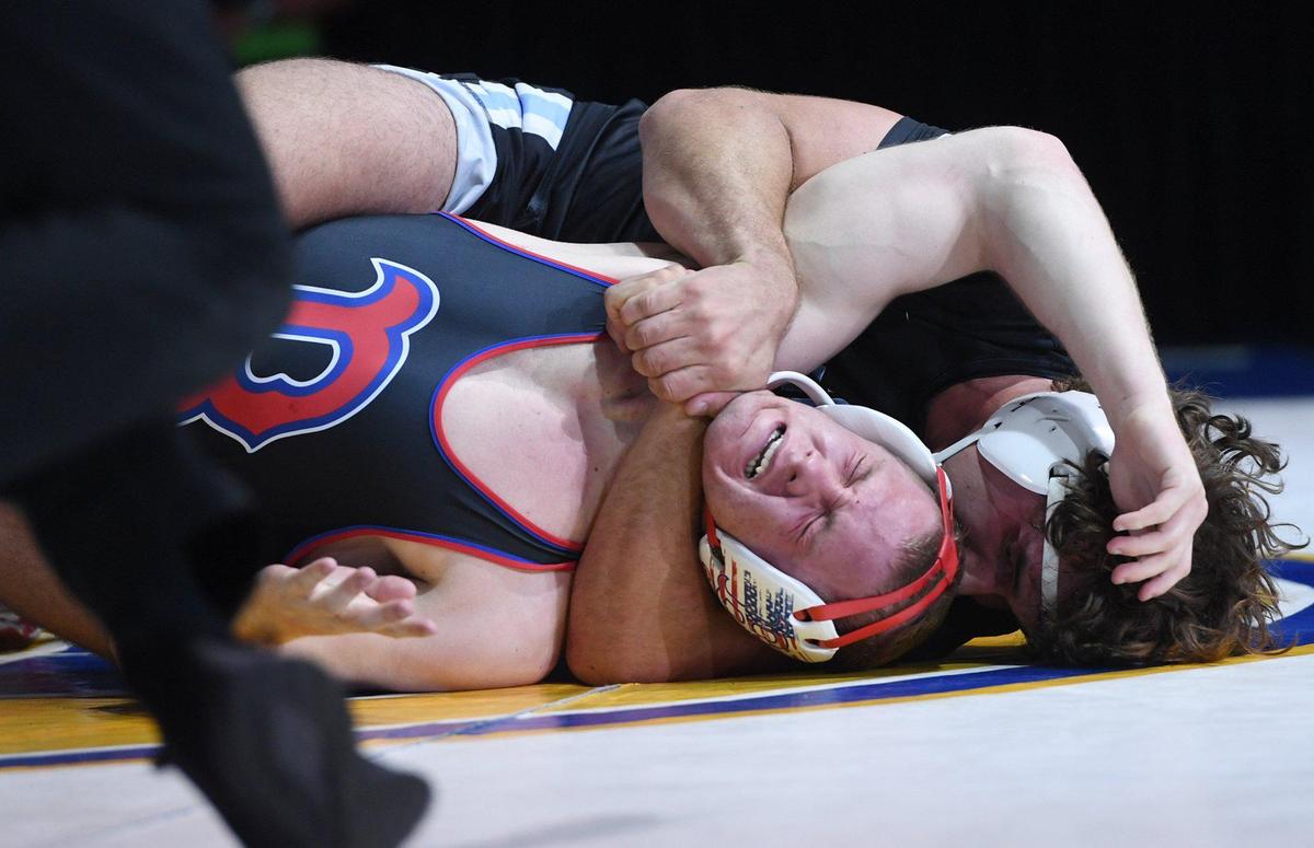 Buchanan’s Caden Rodgers, center, strains in his 220lb match with Clovis North’s Paul Sharp, background, at the CIF state wrestling championships held Sarurday, Feb. 26, 2022 in Bakerfield. Sharp won with a score of 5-3.