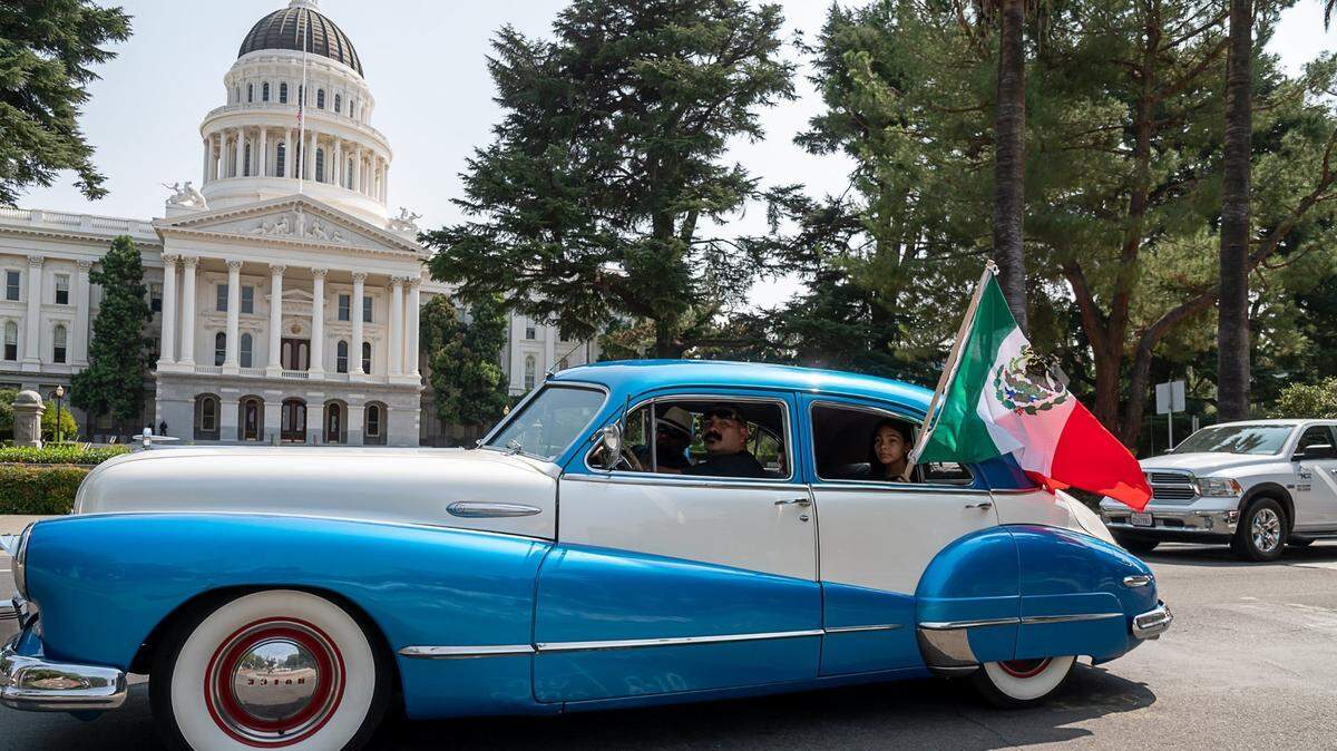Sacramento’s Family First Car & Bike Club drives past the state Capitol in a lowrider caravan to drum up support for Proposition 16 in Sacramento on Wednesday, Sept. 16, 2020.