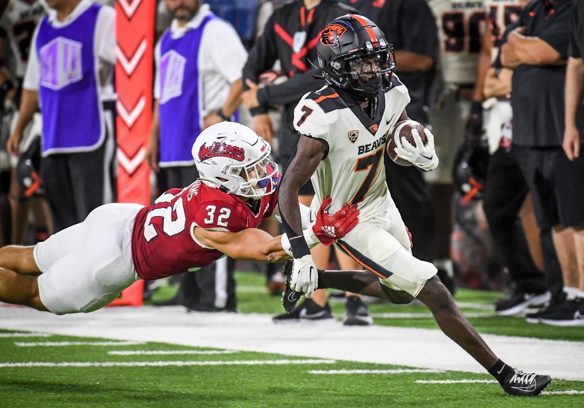 Oregon State’s Silas Bolden pulls out of the grasp of Fresno State’s Evan Williams before heading into the end zone for a touchdown in the fist half of their game at Valley Children’s Stadium in Fresno on Saturday, Sept. 10, 2022.