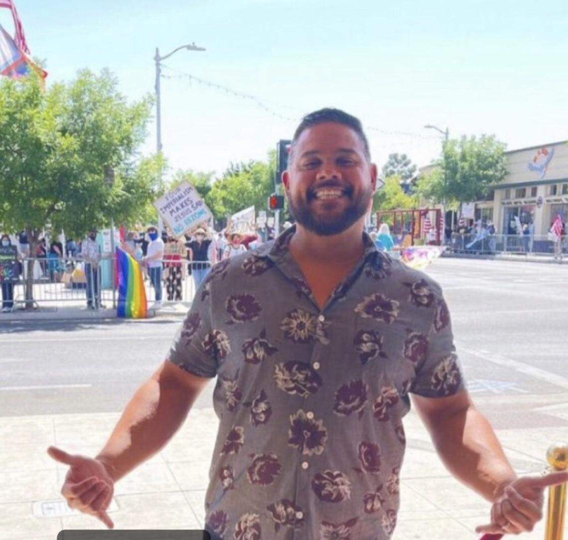 Adventure Church pastor Anthony Flores, a lightning rod in the ongoing protests over the church’s purchase of the Tower Theatre, poses in front of demonstrators in Fresno, California. The picture was later posted Instrgram.