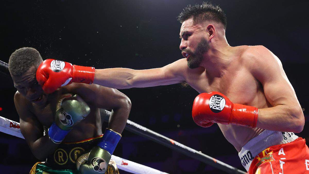 Richard Commey and Jose Ramirez exchange punches during their junior welterweight fight at Save Mart Center on March 25, 2023 in Fresno, California.