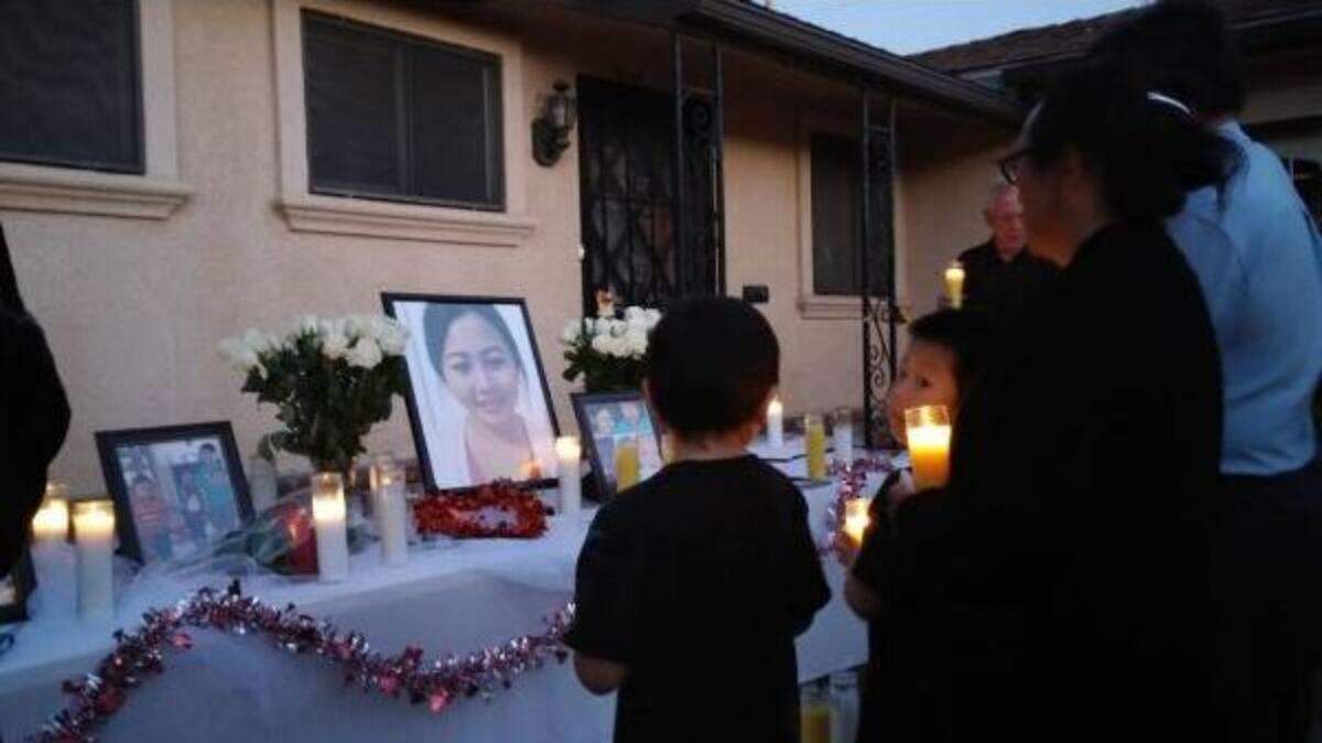 Local Hmong leaders and the family of Xia Vang are shown holding a candlelight vigil at the family’s home in east-central Fresno.