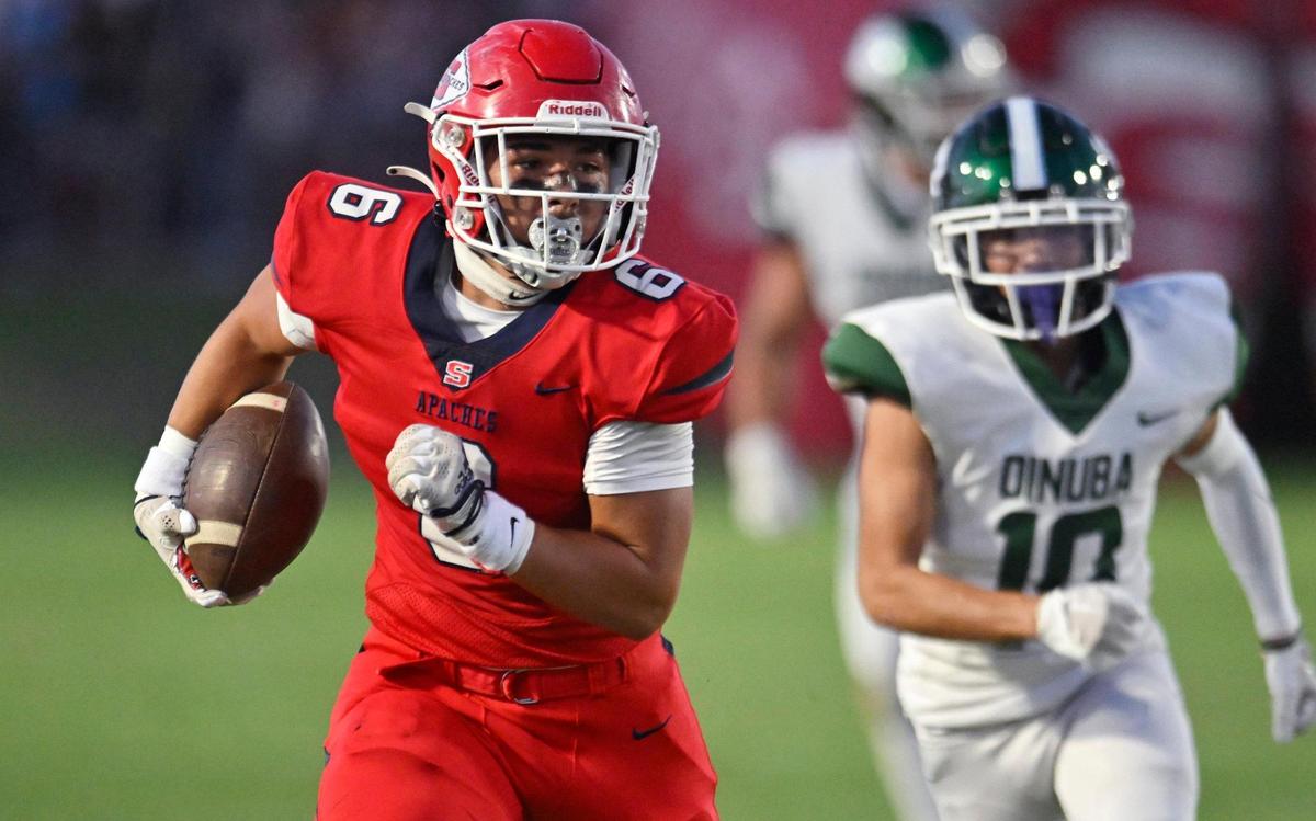 Sanger’s Conner Bohlken, left, runs for a touchdown against Dinuba Friday, Aug. 18, 2023 in Sanger.