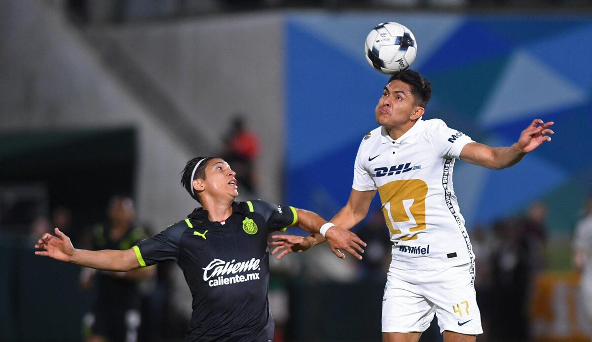 Pumas’ Ricardo Galindo, right, heads the ball with Chivas de Guadalajara’s Angel Zaldivar, left, Wednesday, March 23, 2022 in Fresno.