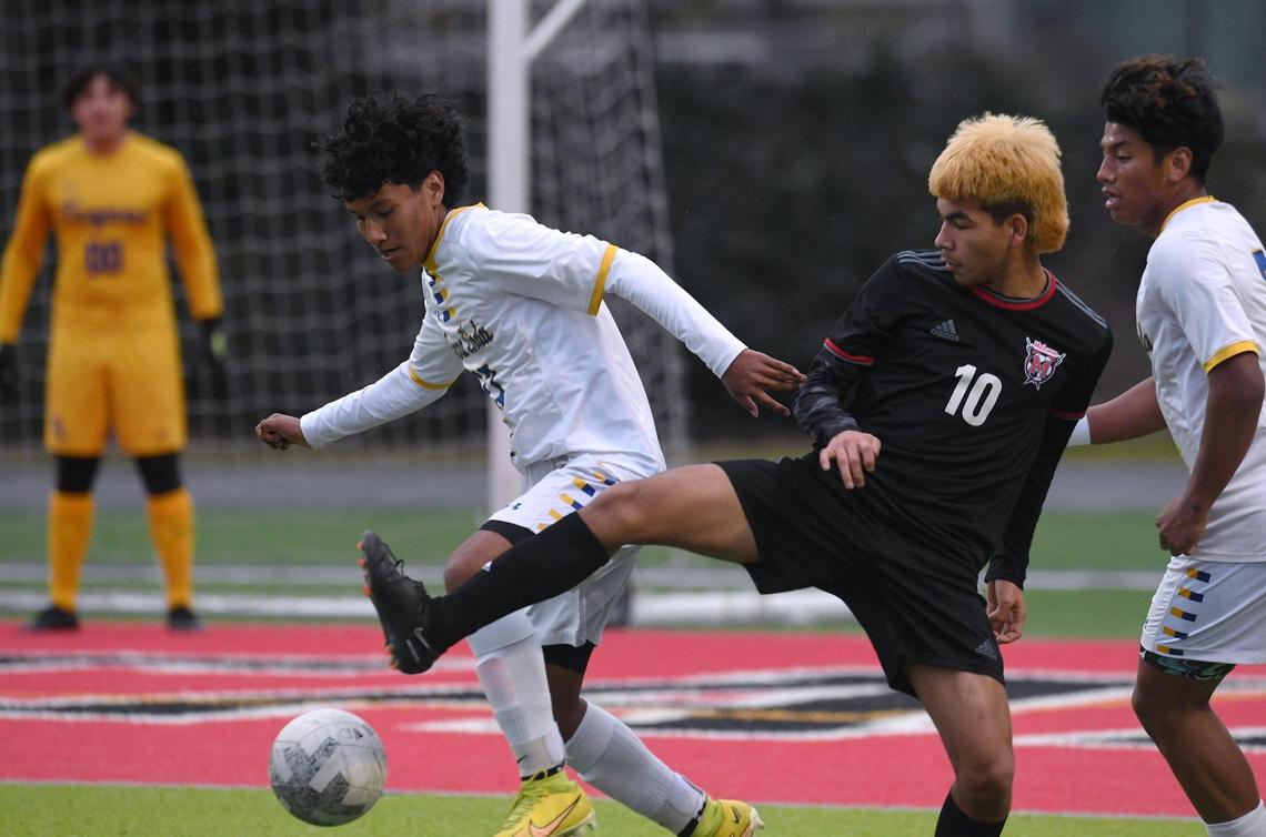 McLane’s Angel Mejia, center, fights for the ball defended by Terra Linda’s Alejandro Gonzalez, left, and Kleber Maldonado, far right, in the CIF Northern California Regional Division III boys soccer championship Saturday, March 4, 2023 in Fresno. Terra Linda won the championship, 2-0.