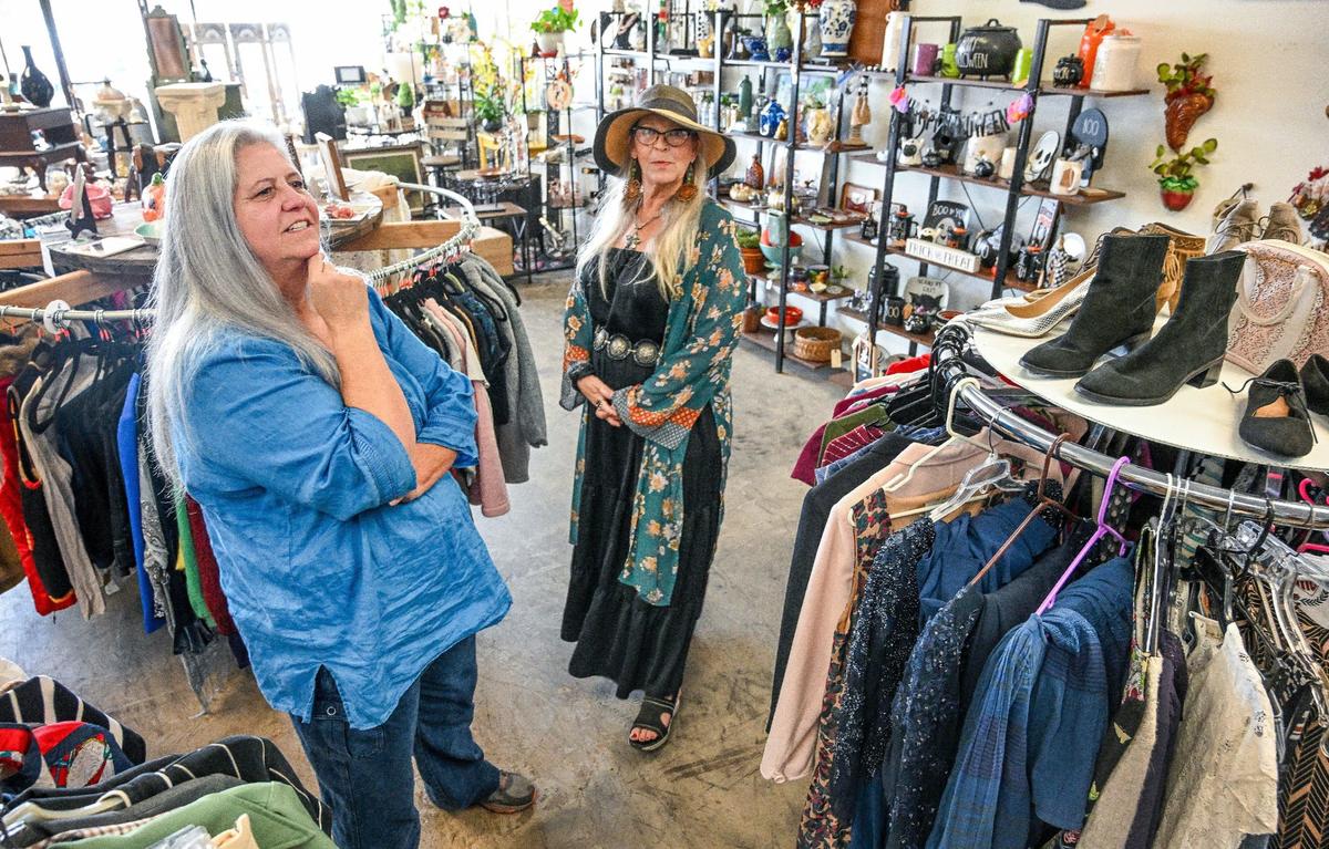Kim Damico, left, and Laura McAtee, partners in Resuscitated marketplace and thrift boutique in Fresno, look over the shop for design ideas.