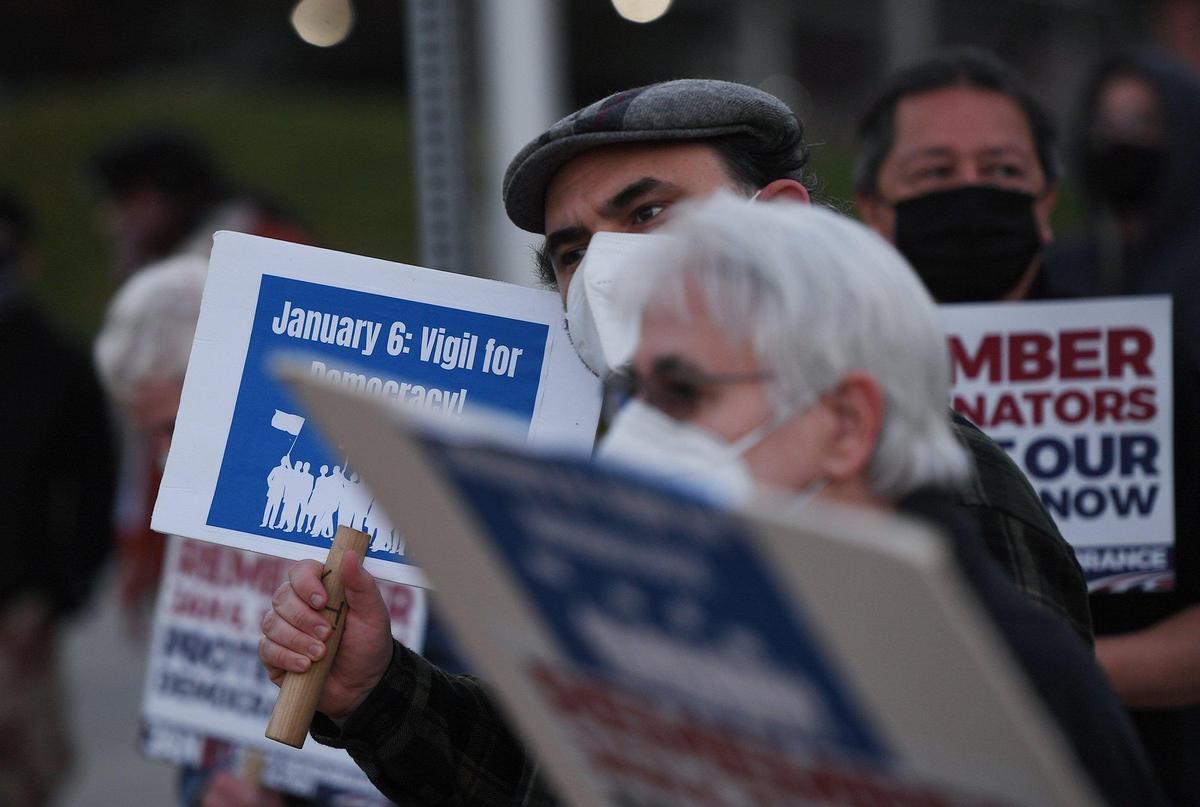 Around 70 people gathered in front of Fresno City Hall for a candlelight vigil, held in support of democracy and against the Jan. 6 uprising one year ago at the nation’s capitol Thursday evening, Jan. 6, 2021 in downtown Fresno.