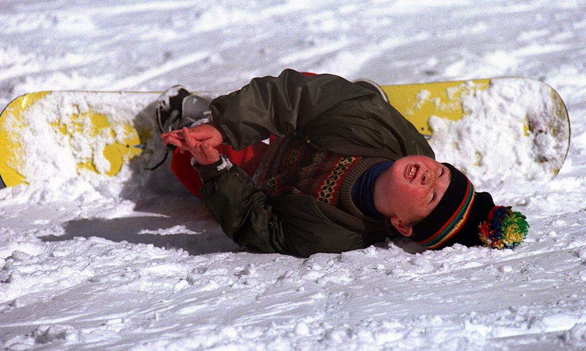 Seven-year-old Taylor Wainwright of Santa Rosa is momentarily stuck after falling on his first day of snowboarding at Badger Pass ski resort in Yosemite National Park as he waits for mom, Paula Wainwright, to help him regain an upright, and downhill, position on Jan. 21, 1999.