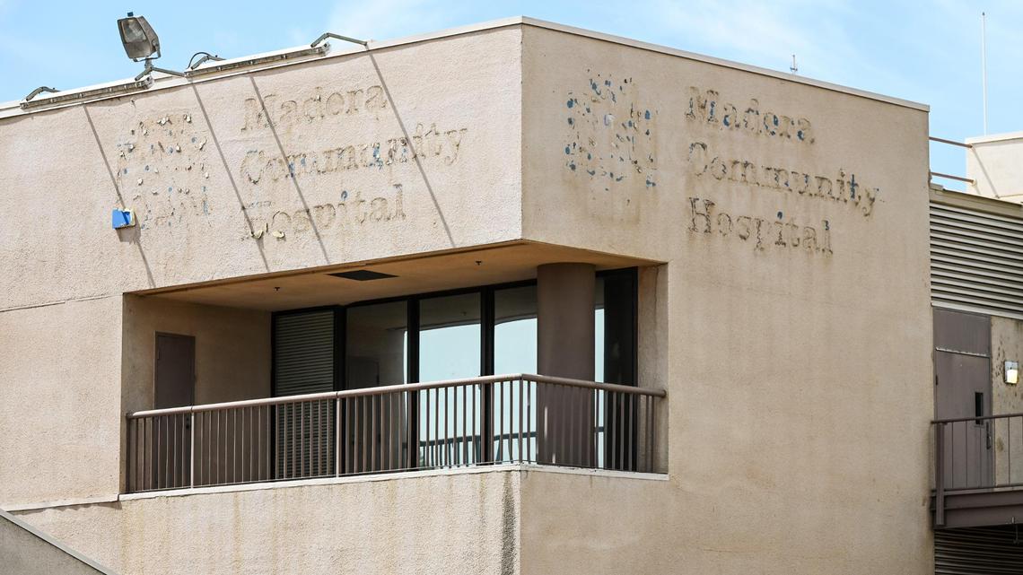 Faded signs are visible on the wall outside Madera Community Hospital on Monday, July 24, 2023. The hospital closed early this year.
