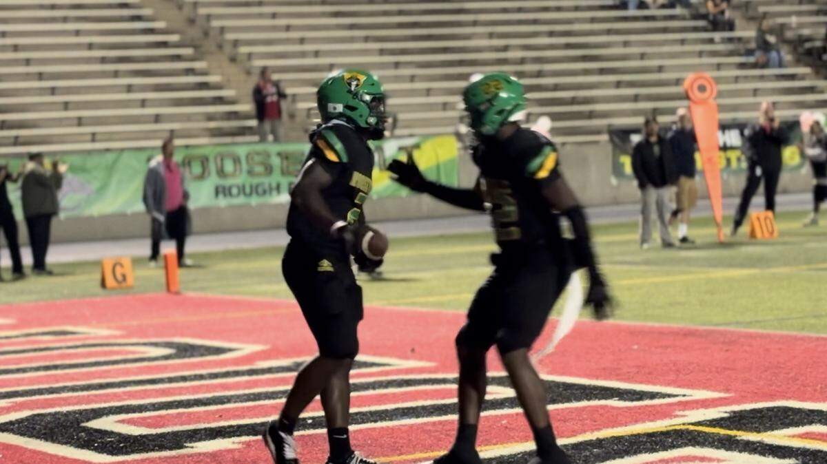 Sunnyside RB Ehis Idoni, left, is congratulated by Jayden Cullin after scoring a touchdown against Sunnyside in a North Yosemite League game at McLane Stadium on Thursday, Oct. 2, 2025.