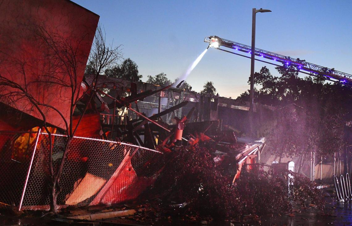 Fresno Fire crews responded to a fenced and boarded structure engulfed in flames at the 1200 block of E Street Friday evening, June 10, 2022 in Fresno. Fresno Battalion chief Dan O’Meara called the structure a complete loss.