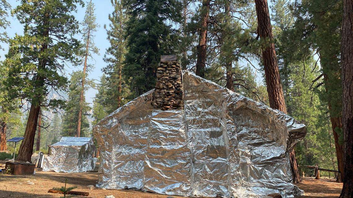 How do you save a rustic building from a wildfire? You apparently wrap it in aluminum foil looking material called structure-wrap, according to the U.S. Forest Service.