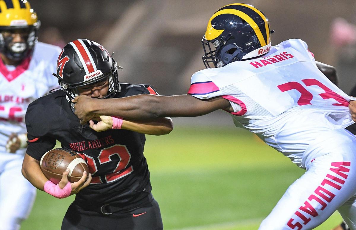 McLane’s Pearson Sengsoulinh, left, gets his face mask grabbed by Sunnyside’s Chance Harris on a run during their football game at McLane Stadium on Friday, Oct. 21, 2022.