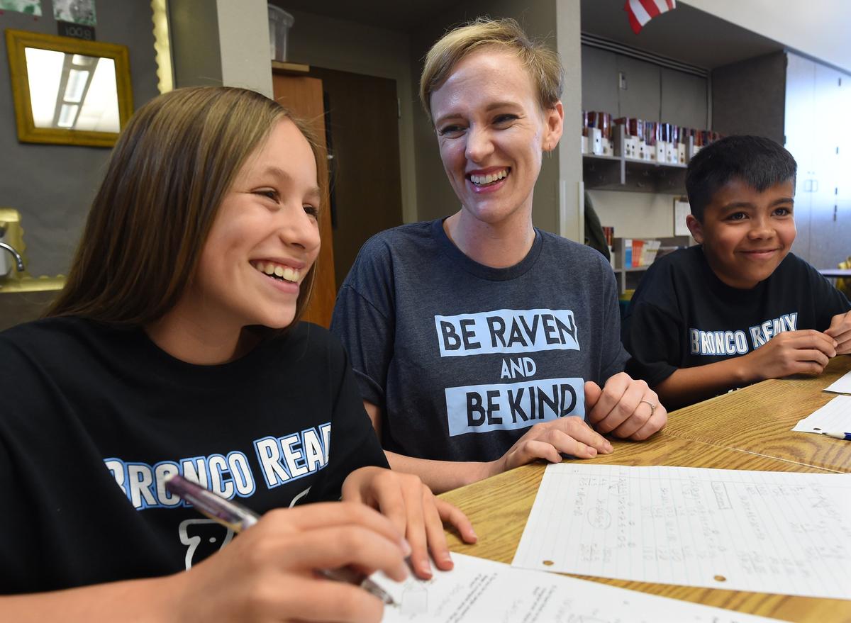 Bud Rank Elementary teacher Allison Vargas visits with her sixth-grade students Abigail Jacobo, left, and Nick Rocha, right, Monday afternoon, March 25, 2019. Vargas is battling colon cancer and will leave the school Friday for a leave of absence to spend more time with her 1 1/2-year-old daughter and husband. Her students have set up a GoFundMe account to help her with expenses.