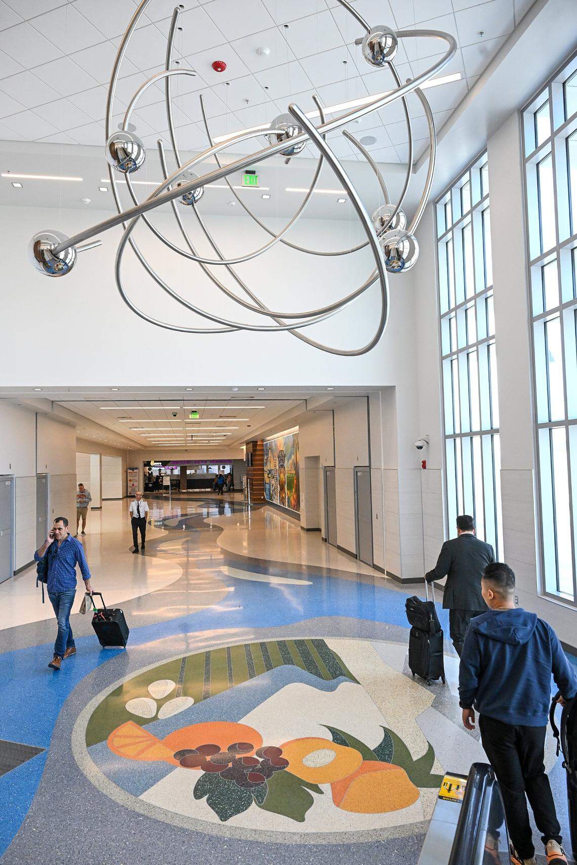 An aerial art sculpture and floor tile display art at the entrance to the new Concourse B at Fresno Yosemite International Airport.