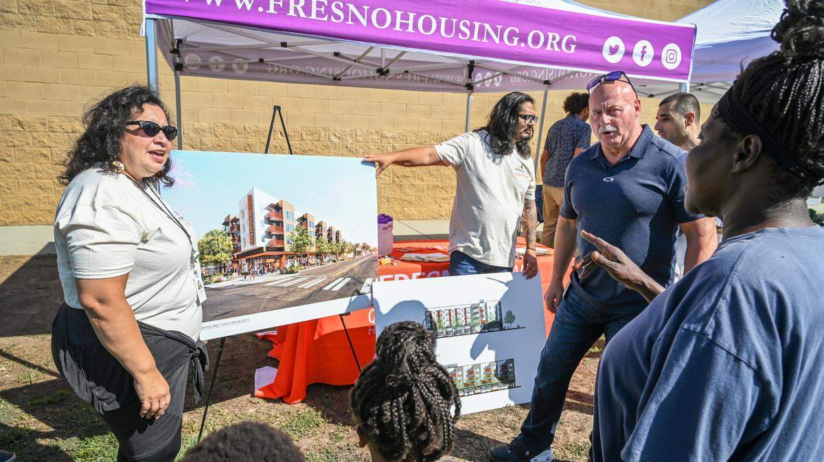 Mayor Jerry Dyer, second from right, talks with organizers and local residents about the Monarch affordable community housing project set to open in Chinatown later this year during a community event held by representatives from about 20 Transform Fresno projects at Maxie L. Parks Community Center in south west Fresno on Saturday, Sept. 24, 2022.