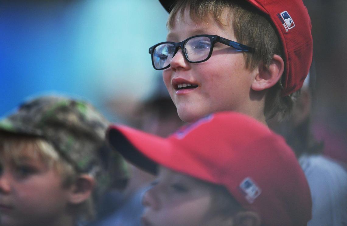 Wyatt Idhe, 6, top, watches game action with his Cal Ripken baseball teammates between the Fresno Grizzlies and the Stockton Ports Friday, April 8, 2022 at Chukchansi Park in Fresno.
