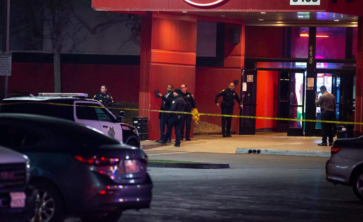 Detectives investigate the scene of a fatal shooting inside a Bowlero bowling alley in northeast Fresno on Friday, Feb. 11, 2022.
