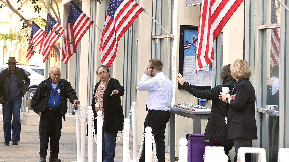A Fresno County Elections official directs a voter to where he can drop off his ballot at the elections office downtown, March 3, 2020.