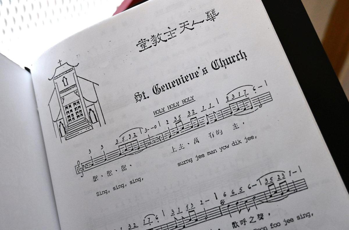 A hymnal offers text in English and Chinese languages at St. Genevieve Catholic Church in Chinatown. Photographed Sunday, Oct. 27, 2024, in Fresno.