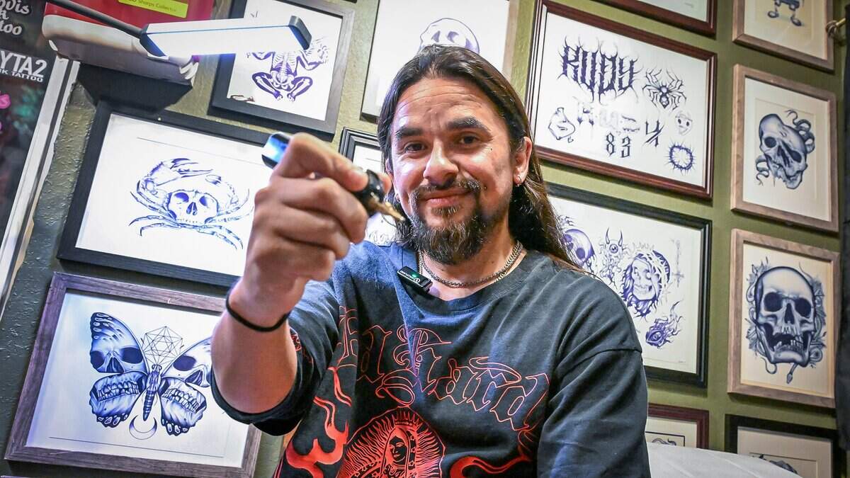 Daniel Rudolfo Acosta III, holds up a newer style tattoo gun, or machine, at Clovis Ink Tattoo, the first tattoo parlor to open in Clovis, on Monday, June 29, 2026.