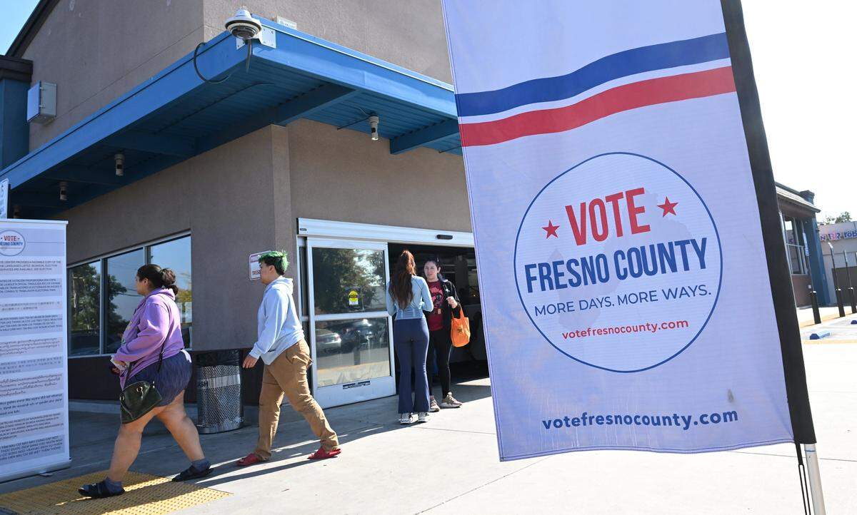 Voters file into and leave the Betty Rodriguez Public Library voting center Tuesday, Nov. 4, 2025 in Fresno.
