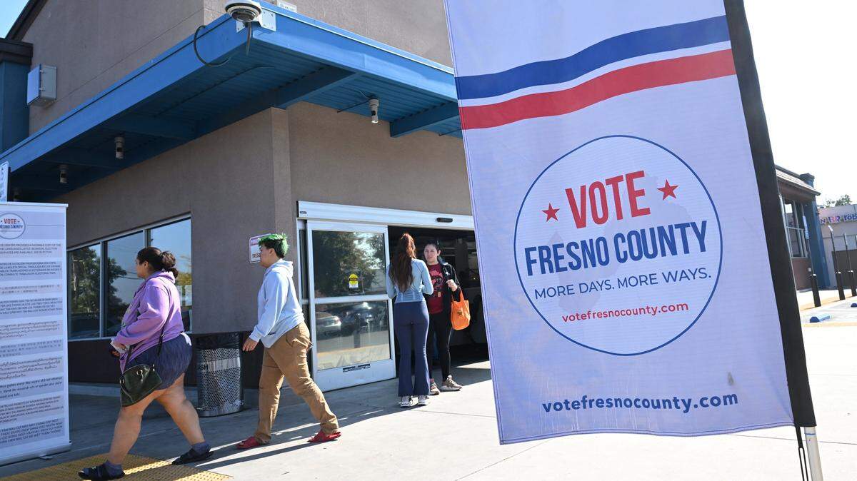 Voters file into and leave the Betty Rodriguez Public Library voting center Tuesday, Nov. 4, 2025 in Fresno.