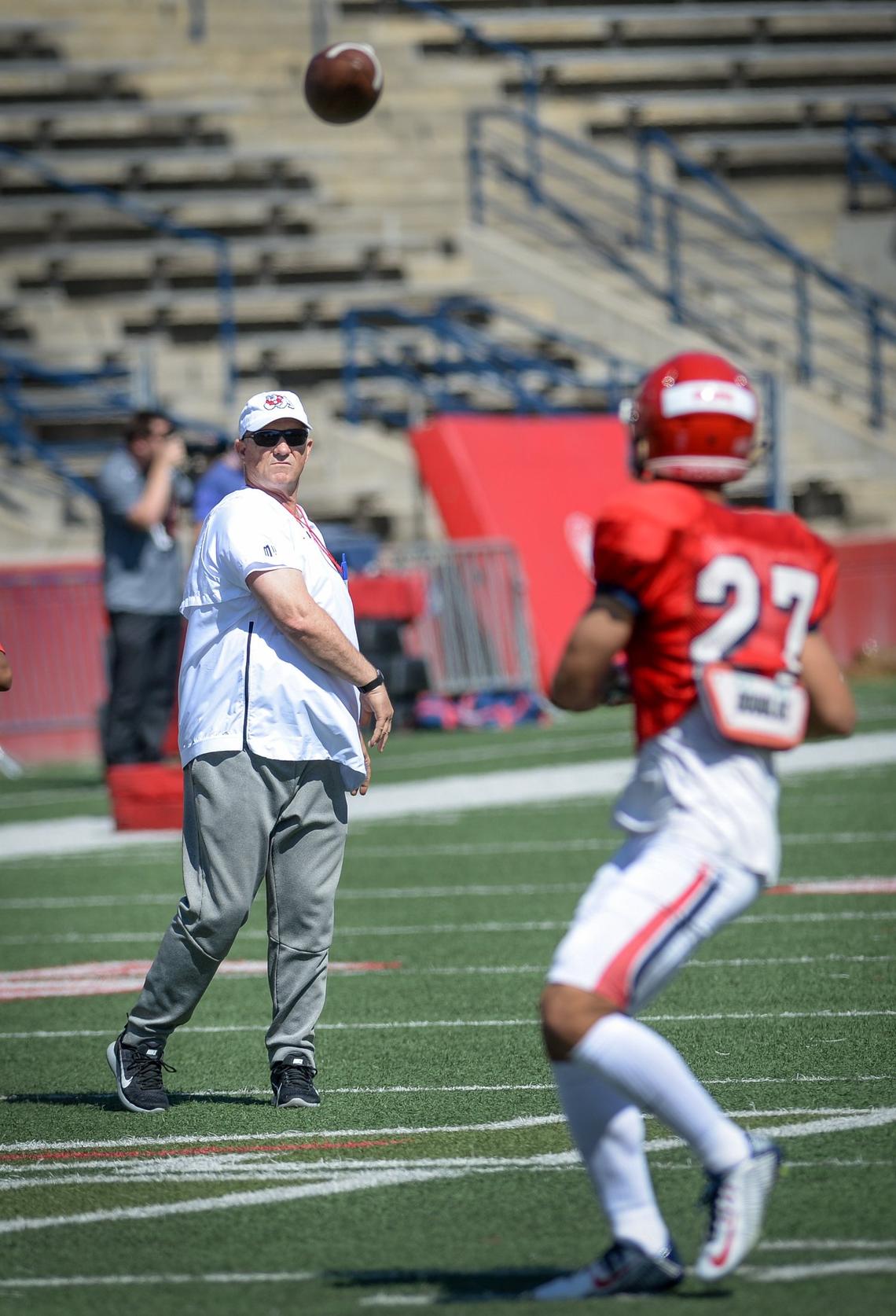 Fresno State coach Jeff Tedford throws to wide receiver Zane Pope during the final spring practice of 2019 at Bulldog Stadium on Saturday, April 13, 2019.