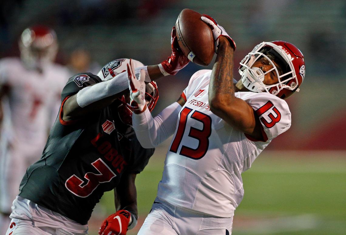 Fresno State wideout Justin Allen (13) tries to reel in a pass while defended by New Mexico cornerback D’Angelo Ross (3) in the Bulldogs’ 38-7 victory over the Lobos at Dreamstyle Stadium in Albuquerque, N.M., Saturday, Oct. 20, 2018.