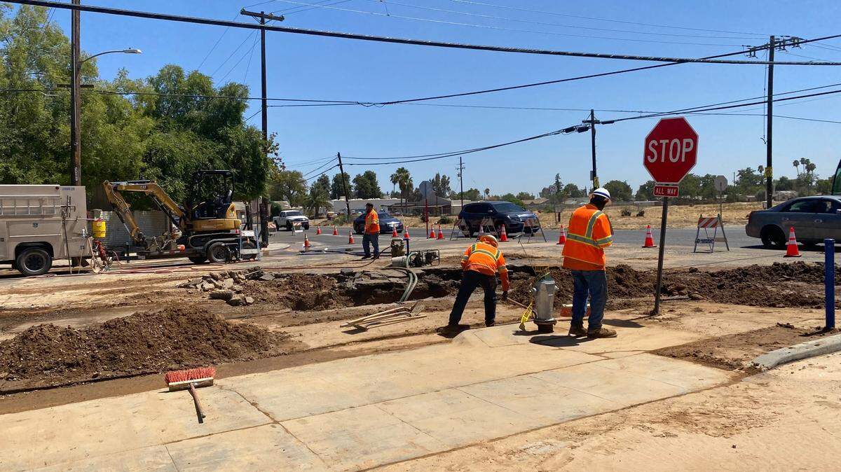 Crews work to fix a water main line break at Olive and Hughes avenues area on Tuesday, Aug. 20, 2024.