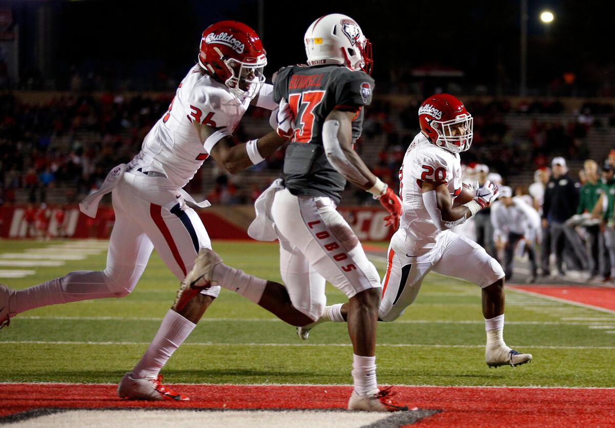 Fresno State running back Ronnie Rivers (20) sprints to the end zone to score a touchdown as teammate Cam Sutton (36) blocks New Mexico cornerback Jalin Burrell (13) in the Bulldogs’ 38-7 victory over the Lobos in Albuquerque, N.M., Saturday, Oct. 20, 2018. The victory was the Bulldogs’ fifth in a row.