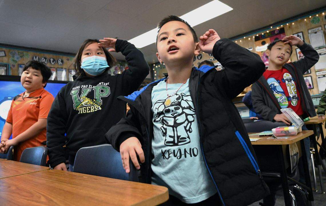 Keyno Yang, right, and other third-grade students take turns singing songs in Hmong and English in Fresno Unified’s Hmong Dual Immersion program at Vang Pao Elementary in 2023.