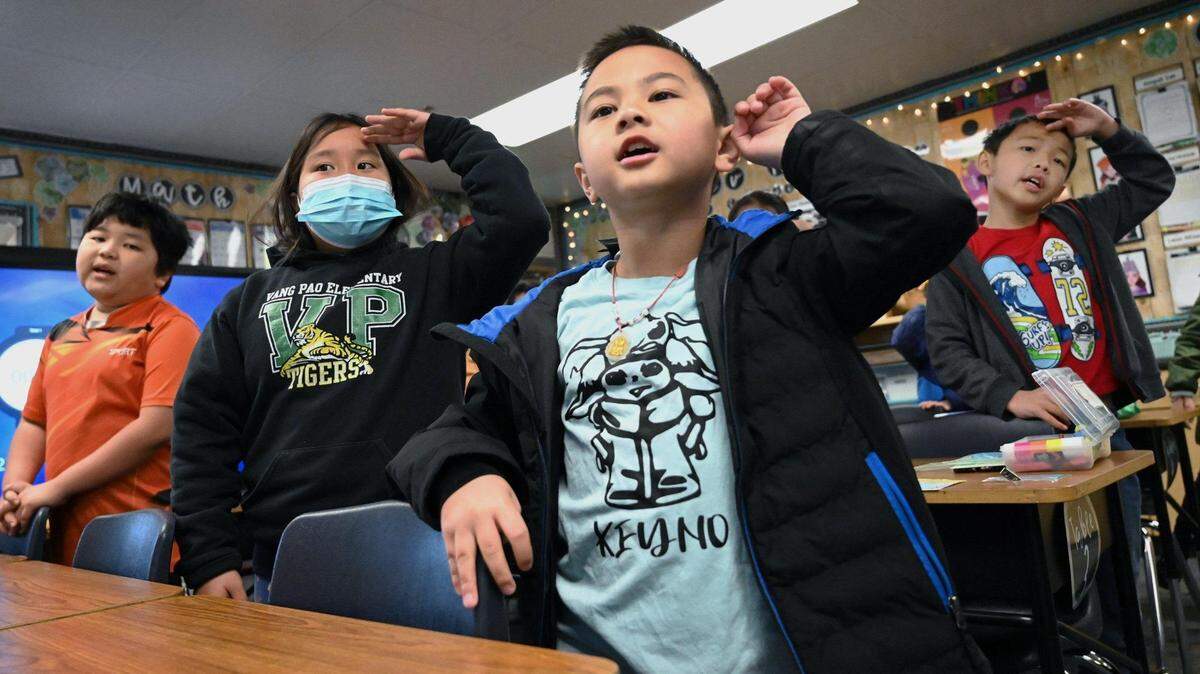Keyno Yang, right, and other third-grade students take turns singing songs in Hmong and English in Fresno Unified’s Hmong Dual Immersion program at Vang Pao Elementary in 2023.