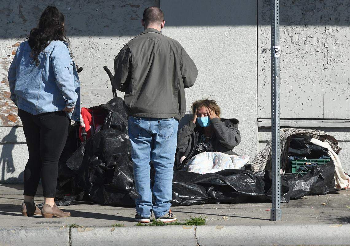 Fresno_Madera Continuum of Care volunteers Ashley Morris and Dylan talk with a homeless person in Fresno’s Tower District during the February 2022 Point in Time count of the homeless. A PIT count was not done in 2023, but the 2025 count is set for Jan. 28-30 in Fresno and Madera counties.