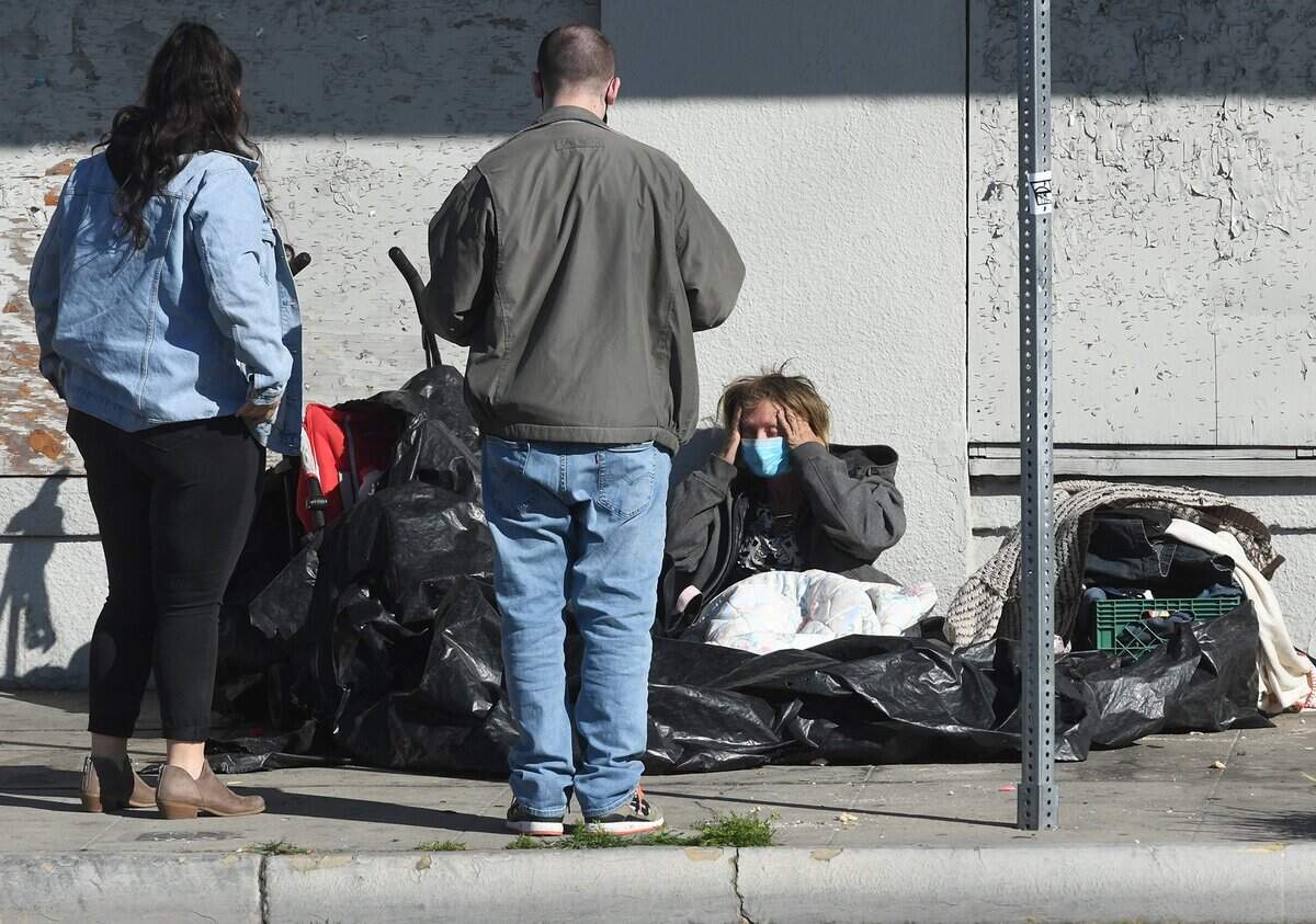 Fresno_Madera Continuum of Care volunteers Ashley Morris and Dylan talk with a homeless person in Fresno’s Tower District during the February 2022 Point in Time count of the homeless. A PIT count was not done in 2023, but the 2025 count is set for Jan. 28-30 in Fresno and Madera counties.