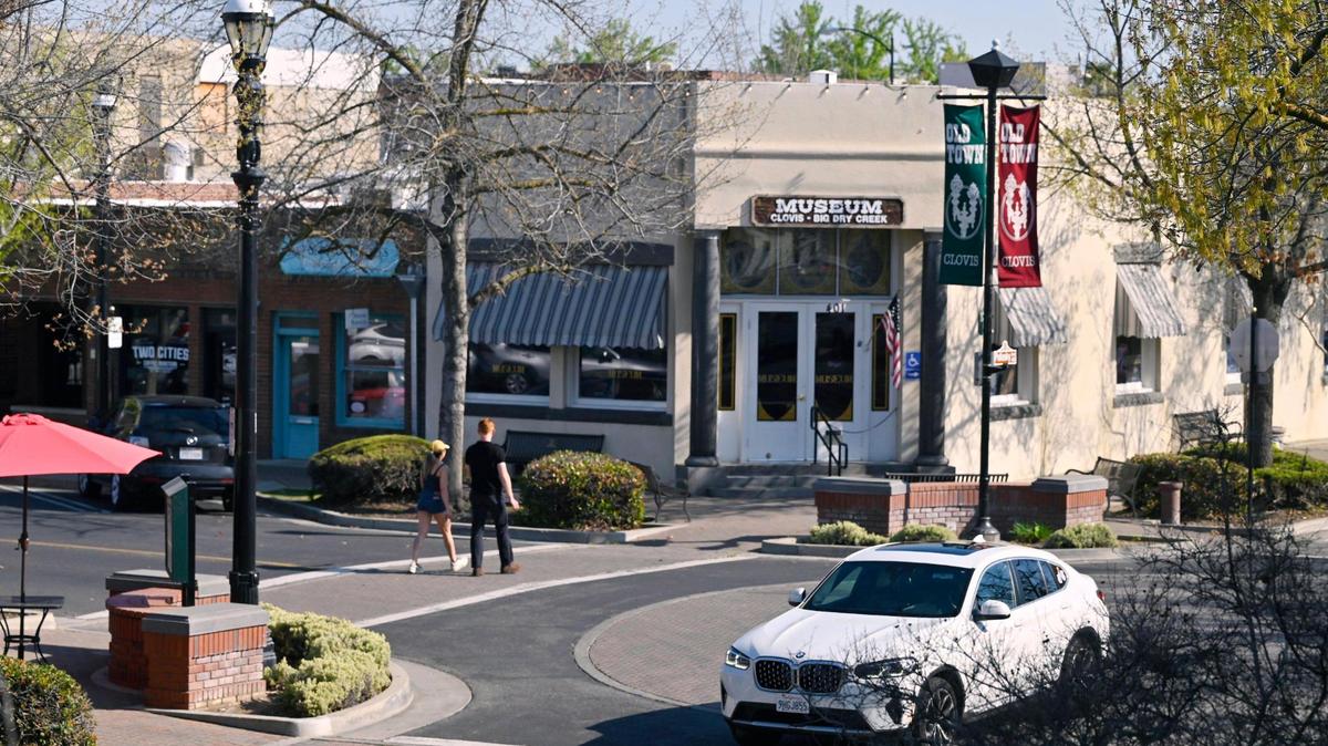 Pedestrians cross Fourth Street along Pollasky Ave. Wednesday, March 26, 2025 in Old Town Clovis.