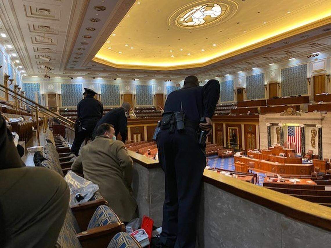 Capitol police prepare to evacuate House members as the riot ensues.